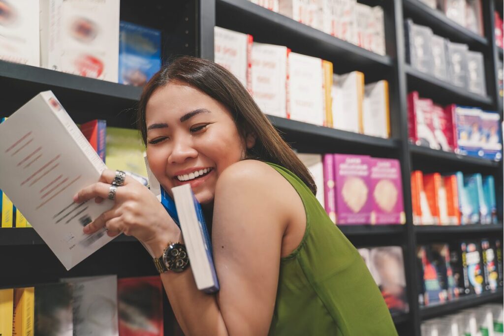 Book Marketing 8 Satisfied Author Embracing Her Books In A Book Store