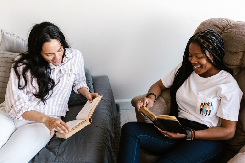 book marketing How to market a memoir - two women reading a book and sharing their thoughts.